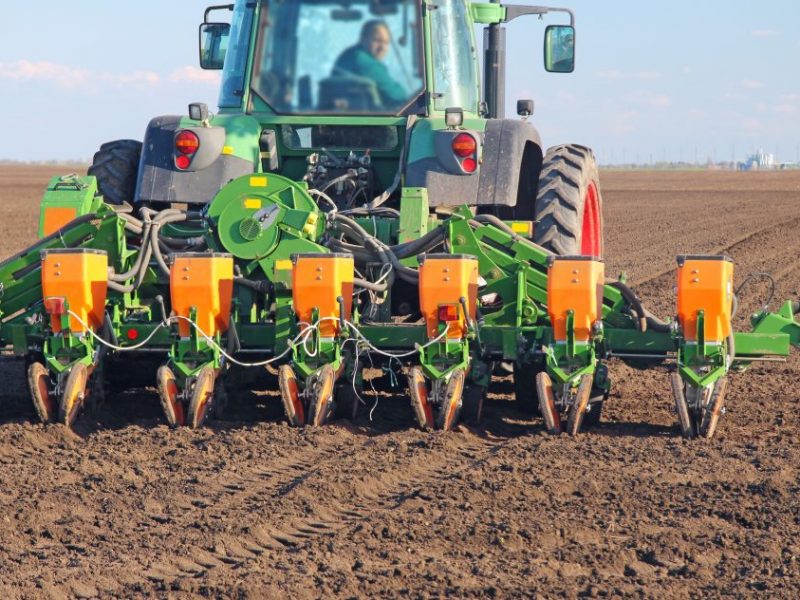 Agricultural tractor sowing and cultivating field